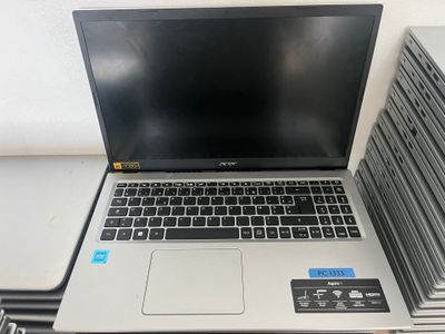 a laptop computer sitting on top of a stack of books