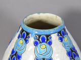 a blue and white vase with a flower design on it
