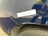 a reflection of a man on the hood of a car