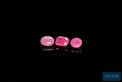 a pair of pink sapphires on a black background