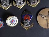a lot of badges that are on a table