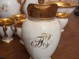 many white and gold vases on a wooden table