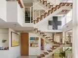 a white couch sitting in a living room next to a staircase