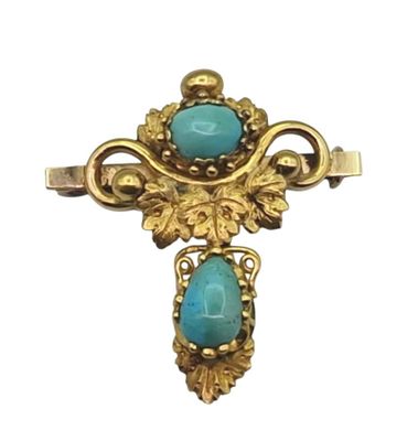 une image représentant une croix en or sertie d'une pierre turquoise