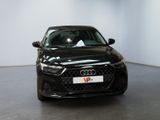 the front of a black audi car parked in a showroom