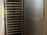 a large stainless steel oven in the corner of a room