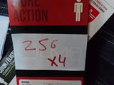 a box with a price tag on it sitting on a pair of jeans