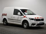 the white van is parked in a room with a checkered floor