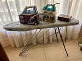 a ironing board with a iron and a box on it