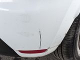 a close up of a car ' s front bumper and tire