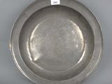 an antique silver plate with a label on it
