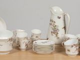 a table with a bunch of dishes and cups on it