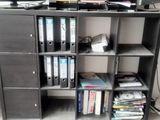 a book shelf with a bunch of books on top of it