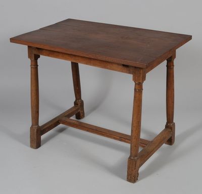 an old wooden table with a wooden top on a grey background