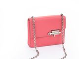 a pink purse with a chain hanging from it ' s side