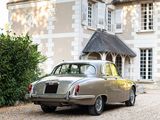 a car that is parked in front of a large house