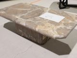 a stone table with a sign on it in a room
