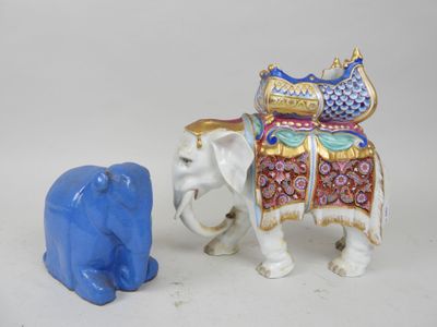 two figurines of elephants that are standing next to each other