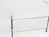 a glass coffee table with brass legs and a glass top