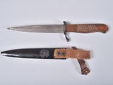 two different types of knives on a white surface