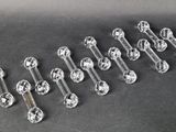 six clear glass knobs on a black surface with a black background