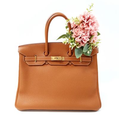 an image of a brown purse with flowers on top of it