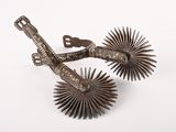 pair of antique metal sunbursts on a white background