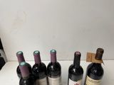 several bottles of wine are lined up on a table