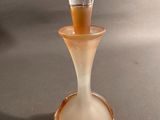 a small glass vase with a light inside of it