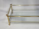 a brass and glass coffee table with a glass top