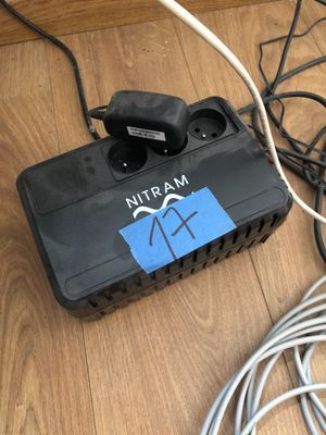 a black box with wires attached to it on the floor