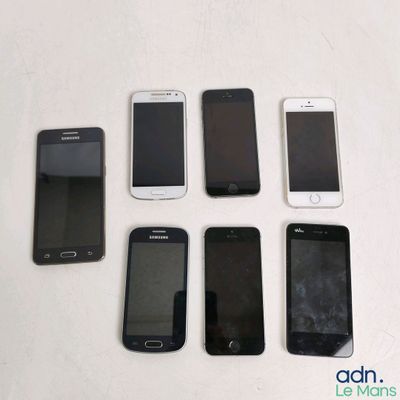several cell phones are lined up in a row on a table