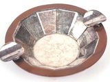a silver and brown bowl with spoons in it
