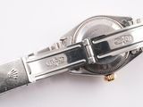 a close up of a watch on a white surface