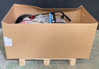 a cardboard box with a bike in it on a pallet