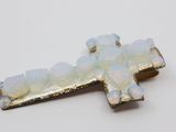 an image of a cross made out of white oplite on a white surface