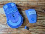 a purple remote control sitting next to a purple mouse