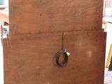 a wooden box with a ring on the top of it