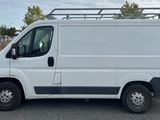 a white van parked in a parking lot near a blue building