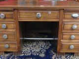 a wooden desk with drawers and a mirror on top of it