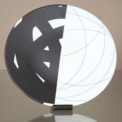 a black and white plate with a white and black design on it
