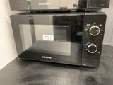 two microwaves on top of each other on a counter