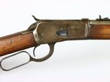 a close up of a rifle on a white surface with a white background