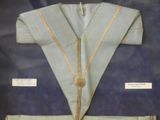 a display case with a blue uniform and a gold ribbon