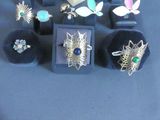 a lot of rings and jewelry on display on a table