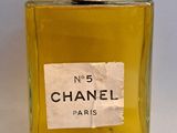 a bottle of perfume sitting on a white surface