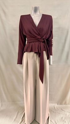 an image of a mannequin mannequin wearing a maroon top and beige pants