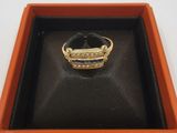 une image représentant une bague dans un écrin posé sur une surface blanche