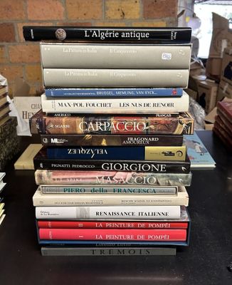 many books stacked on top of each other on a table