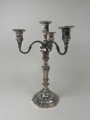 silver plated candelabra with three candles on a stand